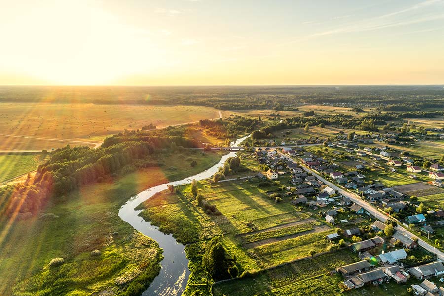 Contact - Aerial View of Small Rural Town at Sunset
