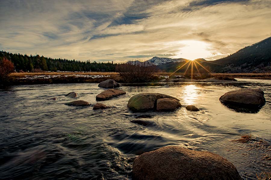 Insurance Quote - View of River and Surrounding Forests at Sunset