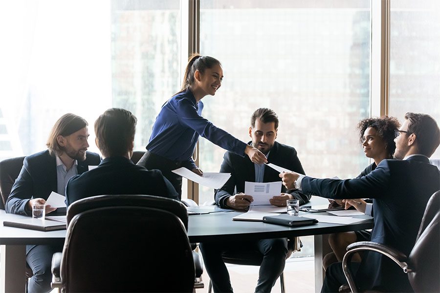 Request Group Benefits ID Card - Business Woman Handing Out Papers During Business Meeting in the Office